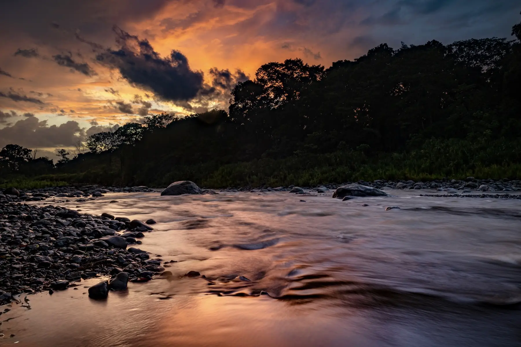 Sunset over the Naranjo River beside the riverfront casitas