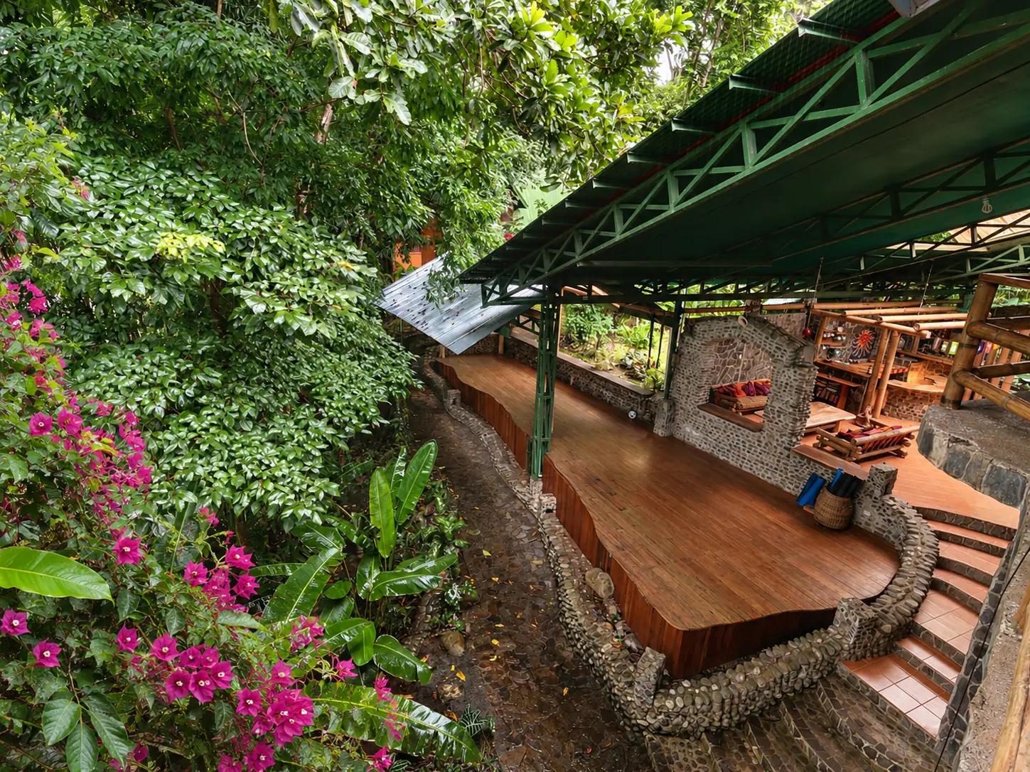 Open-air deck among rainforest trees at Posada Natura